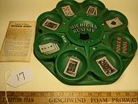 Top view photo of the green Michigan Rummy game board showing card suit compartments and instruction sheet.