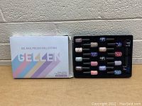 Wide shot of the Gellen Gel Nail Polish Collection with 18 items including bottles of polish and nail care products, box on left and tray with bottles on right.