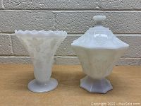 White milk glass ruffled vase and lidded candy dish side by side, showing front view and pattern details.