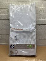 Front view of Sealy Cotton Comfort 3-Sided Contoured Changing Pad in original packaging with label showing product details and features.