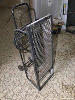 Side and front view of portable propane heater with metal frame and expanded metal grille.