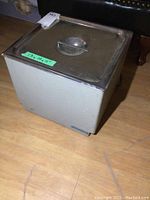 Bransonic 62 ultrasonic parts cleaner unit with stainless steel lid on wooden floor.
