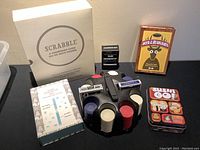 Overview of games including Scrabble, Deer in the Headlights, Our Moments, Sushi Go! and poker chip set