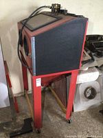 Three-quarter front view of red and black blaster cabinet on stand