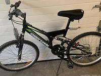 Right side view of the black Supercycle Vice mountain bike showing dual suspension, frame, tires, kickstand, and gel seat.