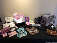 Photo showing black quilted purse, flip flops, sign, multiple books, and makeup bag.