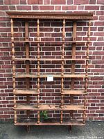 Front view of entire shelving unit leaning against brick wall