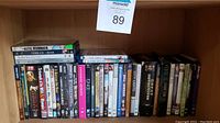 Shelves filled with DVDs and Blu-rays, variety of movie and TV titles visible, arranged upright showing spines.