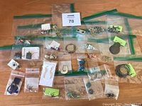 Lot of multiple pairs of pierced earrings in plastic zipper bags, assorted styles and colors