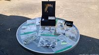 Overview of the jewelry and jewelry box arranged on a round table outdoors