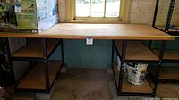 Full front view of workbench showing plywood top and side shelving towers