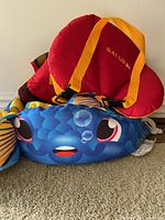 Body Glove puddle jumper with blue fish design, orange fins, and smiling face graphics.