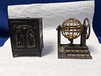 Front view of the black metal bird cage and metal bingo ball stand showing details and approximate size