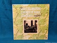 Front cover of the 1946 Duke Ellington Carnegie Hall Concerts vinyl album showing textured green marbled design, band photo, and title.