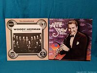Front covers of Woody Herman 1937 album and Artie Shaw 1940-1941 album side by side on blue background.