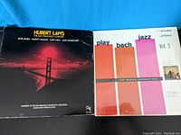 Both vinyl record covers side by side showing album artwork and titles.