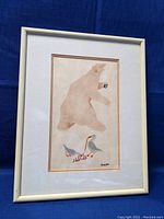 Framed Inuit stone cut print featuring a bear above two birds holding red string, signed by Stanley Elongnak