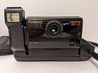 Front view of black Polaroid Captiva SLR SE camera showing lens, flash, and branding.