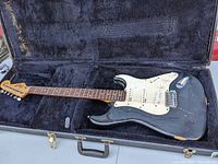 Full view of black Squier Strat in hardshell case