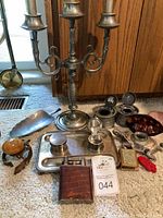 Overall lot shot showing candelabra centered with inkwells, tray and assorted items on carpeted floor