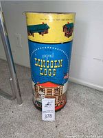 Blue tin container for Lincoln Logs Set 5C, full front view with label and vintage artwork.
