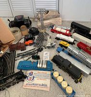 Overall layout showing transformer, controllers, track sections, rocket launcher car, manual and assorted cars