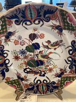 Full frontal view of one 9” plate showing Lyre Bird pattern and scalloped rim.