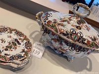 Group view of covered tureen and two platters