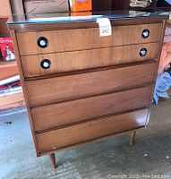 Front view showing four drawers and circular recessed pulls