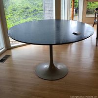 Full view of round table showing tabletop and pedestal base