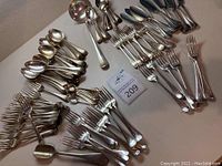 Overall assortment of 95 silverplate flatware pieces displayed on table