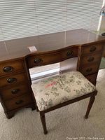 Full front view of the vintage wooden vanity/desk with bench underneath.