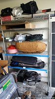 Metal wire rack filled with various household items excluding rack for sale