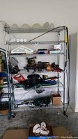 Front view of the metal wire shelving rack with various items placed on shelves, demonstrating shelving structure and size.