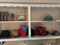Shelf with women's hats and metal bookends