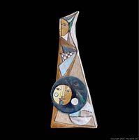 Front view of the triangular ceramic vase with colorful raised figurative faces and hands.