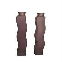 Front view of two vintage Ikea wavy frosted glass vases standing side by side showing their wavy rectangular bodies and narrow tops.