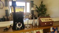Wide view of Air Innovations humidifier and kitchen items including dispensers, wooden box, and utensil