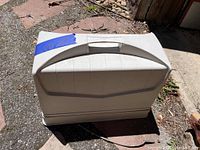 Closed portable cream plastic case with handle to house sewing machine.