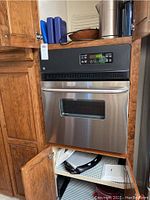 George Foreman grill in cabinet with oven above and other kitchen items below