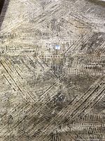 Shows overall pattern and condition of the Amara area rug in charcoal color, highlighting geometric linear abstract design.