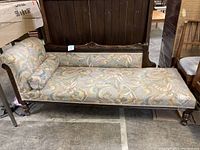 Full side view of a vintage chaise lounger showing the fabric upholstery and wooden frame.