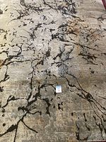 Full view showing the abstract modern pattern in neutral tones with black accents and some rust colors.