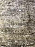 Full view of the Veronica area rug showing its textured grey and beige pattern.