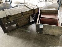 Photo of wooden chicken coop and two wooden crates on concrete floor showing overall shape and condition.