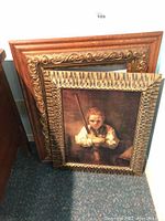 Framed reproduction painting featuring a young girl with a broom placed against a wall alongside two empty ornate frames.