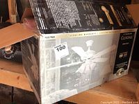 Photo of original box showing the ceiling fan model number 460 964 and brand Hampton Bay with product image.