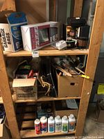 Shelf with boxed mailbox, garbage bags, cleaning products, paint accessories and steel wool