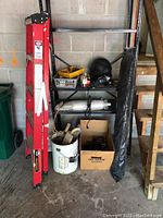 Full lot including ladder, vapor barrier, plastic wrap, power drill, angle grinder, and storage shelf (not included)