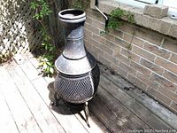 Full front view of chimenea on wooden deck